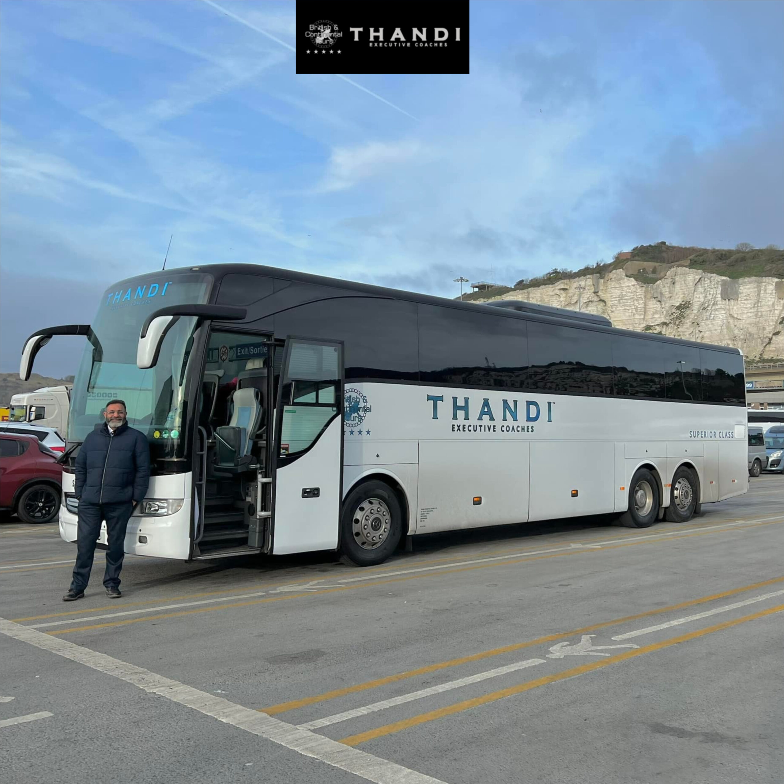 THANDI Executive Coaches luxury white coach parked at port terminal