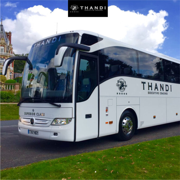 White Thandi Superior Class luxury executive coach parked on a scenic estate road.